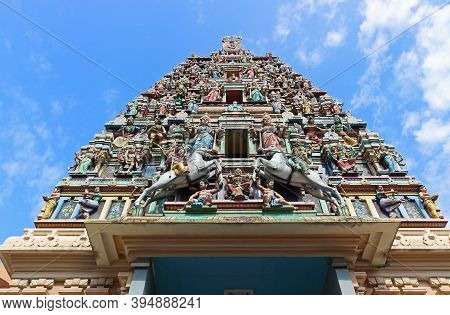 Fragment Of Sri Maha Mariamman Temple Entrance Roof Decorated With Colorful Statues Of Hindu Gods. O
