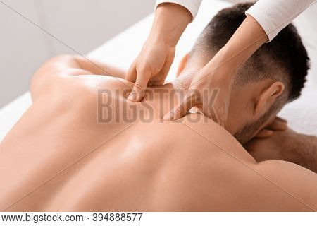 Closeup Of Man Getting Acupressure Massage At Spa Salon, Top View. Female Masseuse Massaging Unrecog
