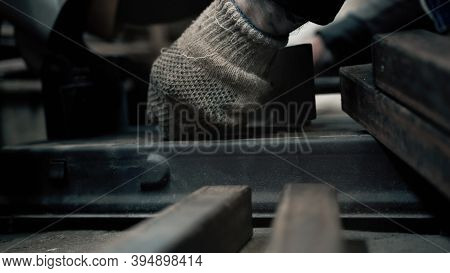 A Worker With Gloves Tightens The Bolts In A Metal Machine