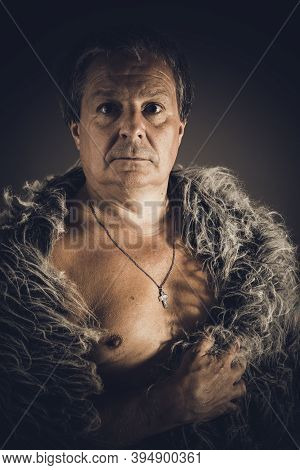Solid Middle-aged Man In A Fur Mantle