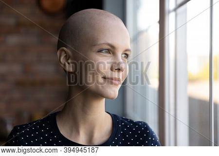 Hopeful Millennial Woman Having Oncological Disease Dreaming Near Large Window