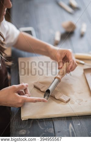 Female Potters Hand Making Clay Pottery At The Table With A Different Wooden Tools Close Up.