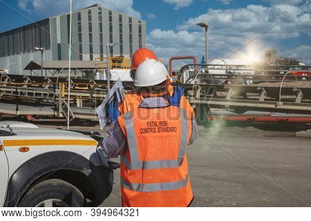 two engineers discussing production plans at a processing plant at a diamond mine in Botswana