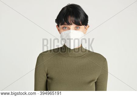 Face mask mockup on a women in a green turtleneck top