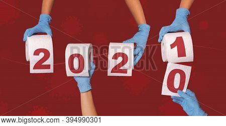 Hands Holding Toilet Paper Rolls. Happy New Year 2021 Concept After The Coronavirus Pandemic Crisis 