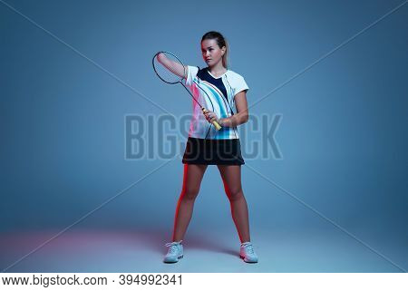 Beautiful Handicap Woman Practicing In Badminton Isolated On Blue Background In Neon Light. Lifestyl