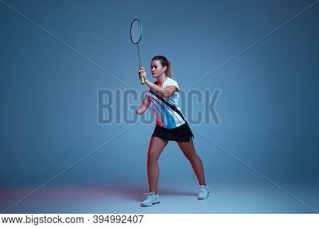 Beautiful Handicap Woman Practicing In Badminton Isolated On Blue Background In Neon Light. Lifestyl