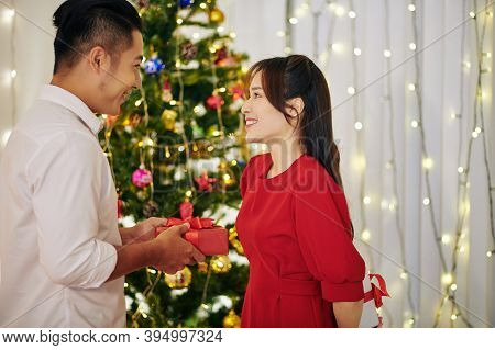 Happy Beautiful Young Vietnamese Couple Exchanging Presents On Christmas Eve