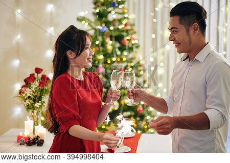 Happy Young Asian Boyfriend And Girlfriend Drinking Champagne And Burning Bengal Lights When Celebra