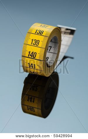 yellow tape measure, symbolic photo for diet control and precision