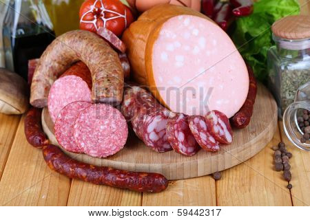 Different sausages on wooden table close-up