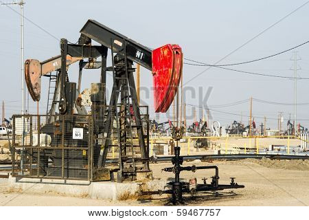 KERN COUNTY, CALIFORNIA - NOVEMBER 26, 2013: Pumpjacks extract oil from an oilfield in Kern County, CA. About 15 billion barrels of oil could be extracted using hydraulic fracturing in California.