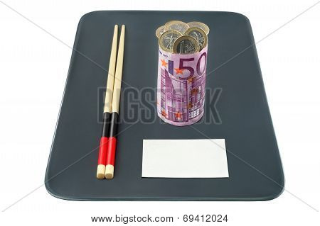 Concept - Bank Loans. Euro banknote in the form of sushi stuffed with coins, with a business card on