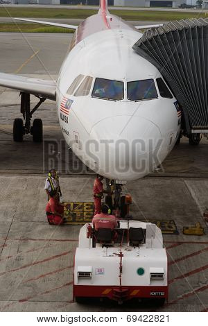 KUCHING - MAY 06: docked jet Airasia airplane on May 06, 2014 in Kuching, Malaysia. AirAsia Berhad is a Malaysian low-cost airline headquartered in Kuala Lumpur, Malaysia