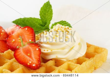 Belgian waffle with whipped cream and strawberries