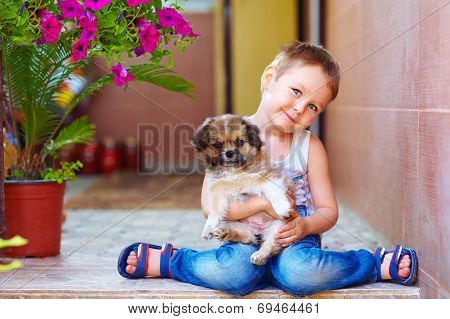 Young Boy Hugging Little Puppy