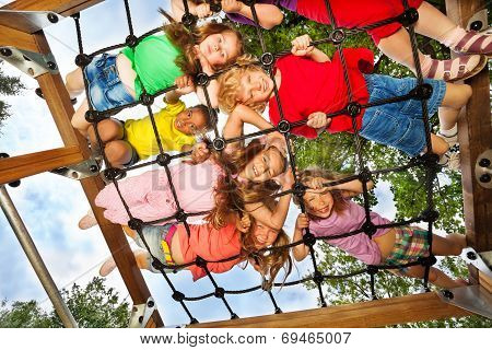 Children look though gridlines of playground