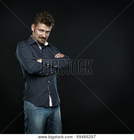 Bearded man with smart smile crossed arms
