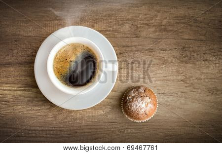 Cup of coffee with cupcake