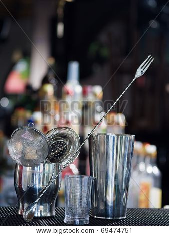 Bartender tools at the club over dark background - selective focus