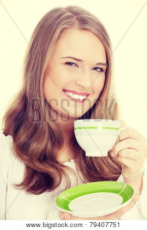 Young attractive corpulent blond woman drinking coffee