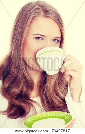 Young attractive corpulent blond woman drinking coffee