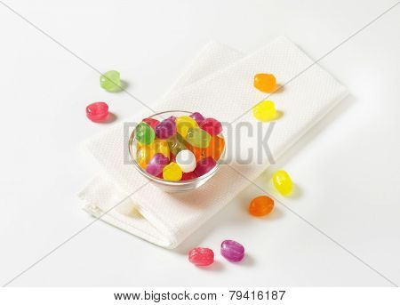 fruit jelly beans in the glass bowl with fabric linen