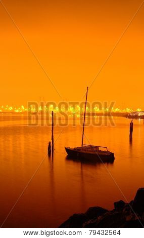 Boat anchored on calm water at night
