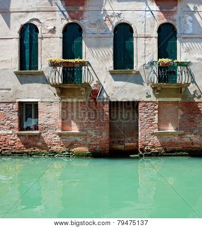 Fassade Of Old Venetian House Standing In Water