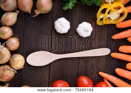 Fresh vegetables and wood cooking spoon
