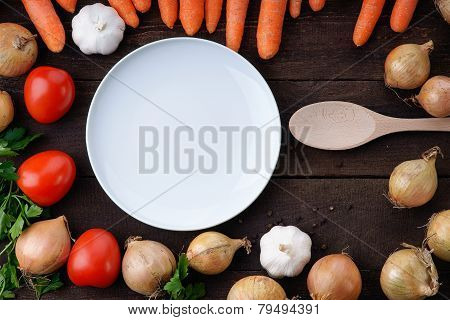 White dish and cooking spoon with vegetables on the table