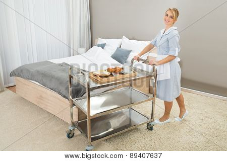 Woman Pushing Trolley With Breakfast