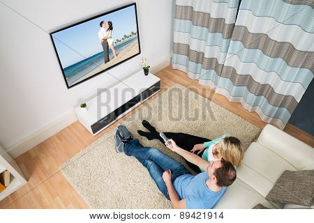Couple Sitting In Front Television