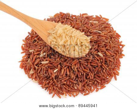 Brown Rice In A Wooden Spoo And Pile Of Red Rice