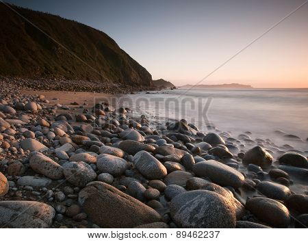 Rocky Beach At Sunset.