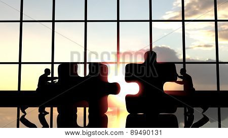 Men pushing pieces of puzzle to assemble them.