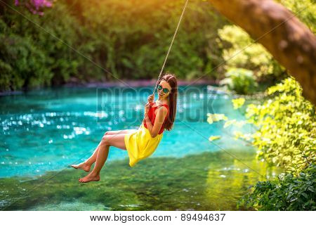 Woman swinging on the river