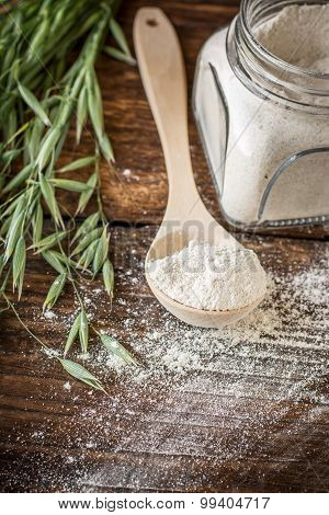 Oat flour, grain oats on wooden background
