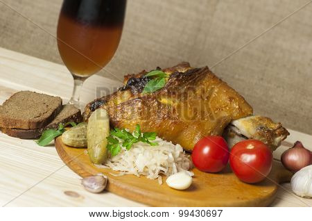 Roasted Pork Leg Served With Sauerkraut And Sliced Beer