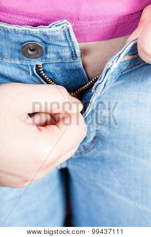 Female Hand Zips Up Jeans Zipper