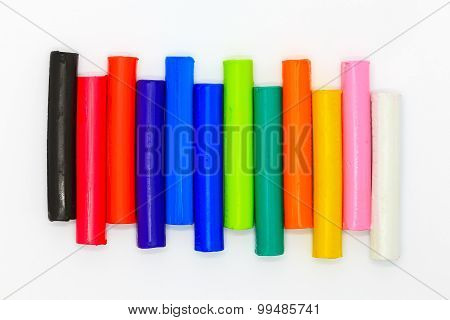 Colors children's clays sticks on a white