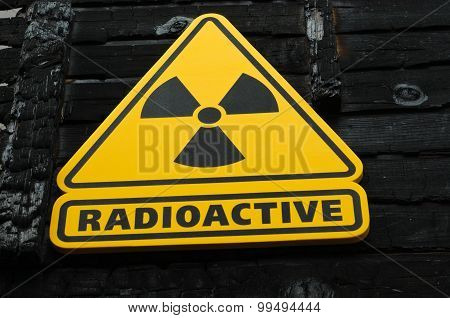 Radioactive Sign On Burned Wooden Background