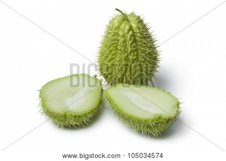 Whole and half spined fresh chayote fruit on white background