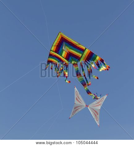 Colorful Kites Flying  In Single File In The Sky