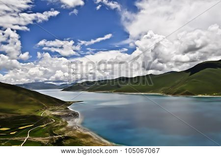 YamdrokTso Lake of Tibet with mountains and blue sky