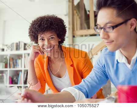 Two desingers working on a project together in office