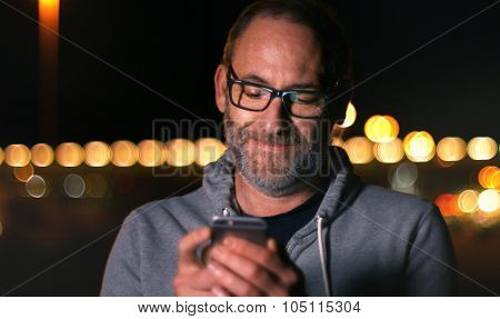 Handsome Mature Man Speaking On Smart Phone At Autumn Sunset In City