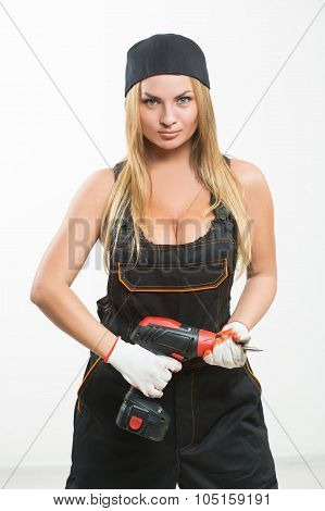 Young sexy female holding a cordless screwdriver