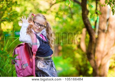 Adorable school girl backpack notes outdoor. Back to school.