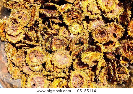 Fried bittergourd chips kept on a bowl